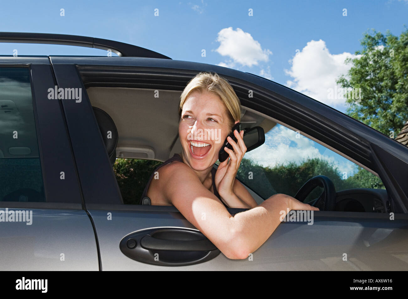 Woman in car using mobile phone Stock Photo
