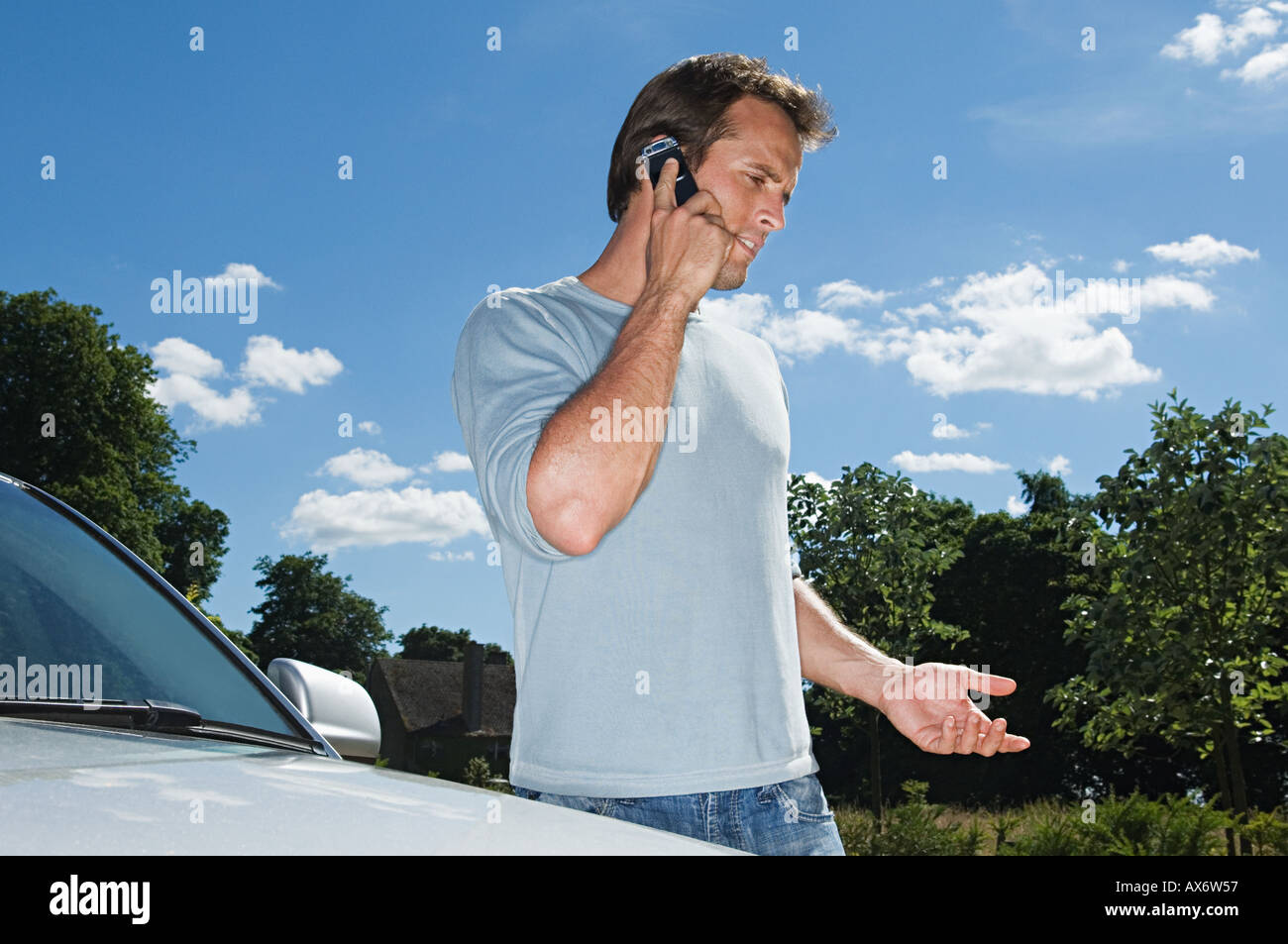 Man on mobile phone by his car Stock Photo