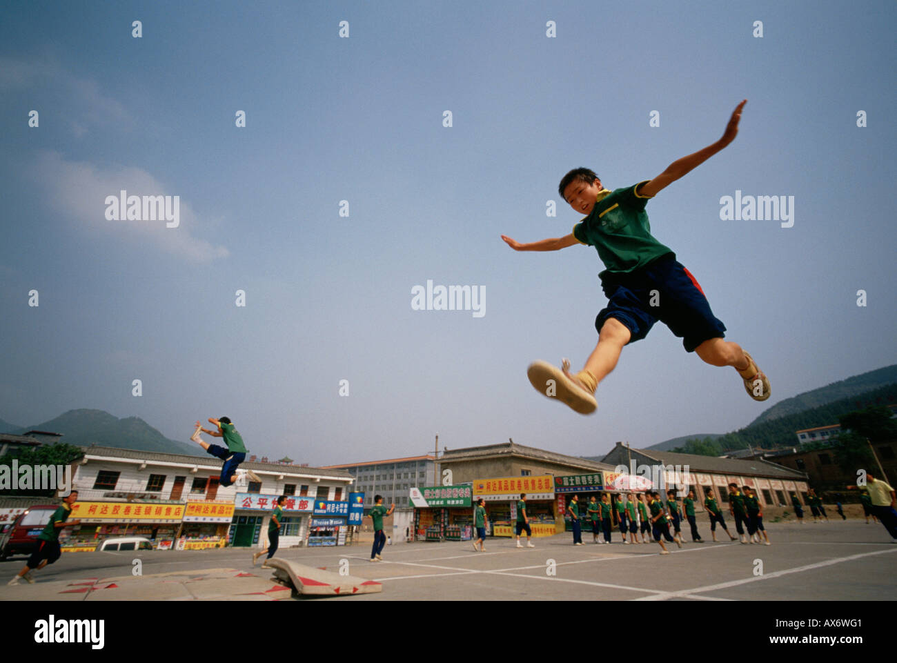 A young Chinese boys practice kung fu kicking at the Ta Gou kung fu school in Shaolin Stock