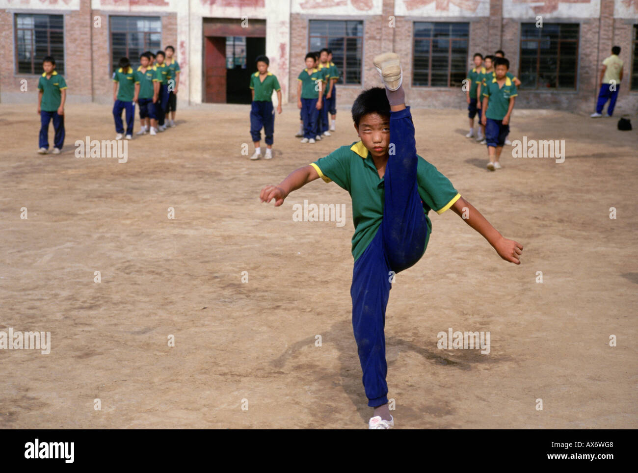 A young Chinese boy practices kung fu kicking at the Ta Gou kung fu school in Shaolin Stock