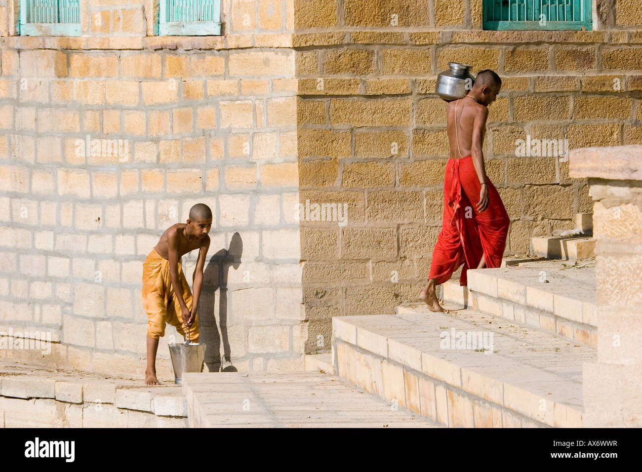 peolple carrying water from Gadi Sagar lake Jaisalmer Rajasthan India Stock Photo