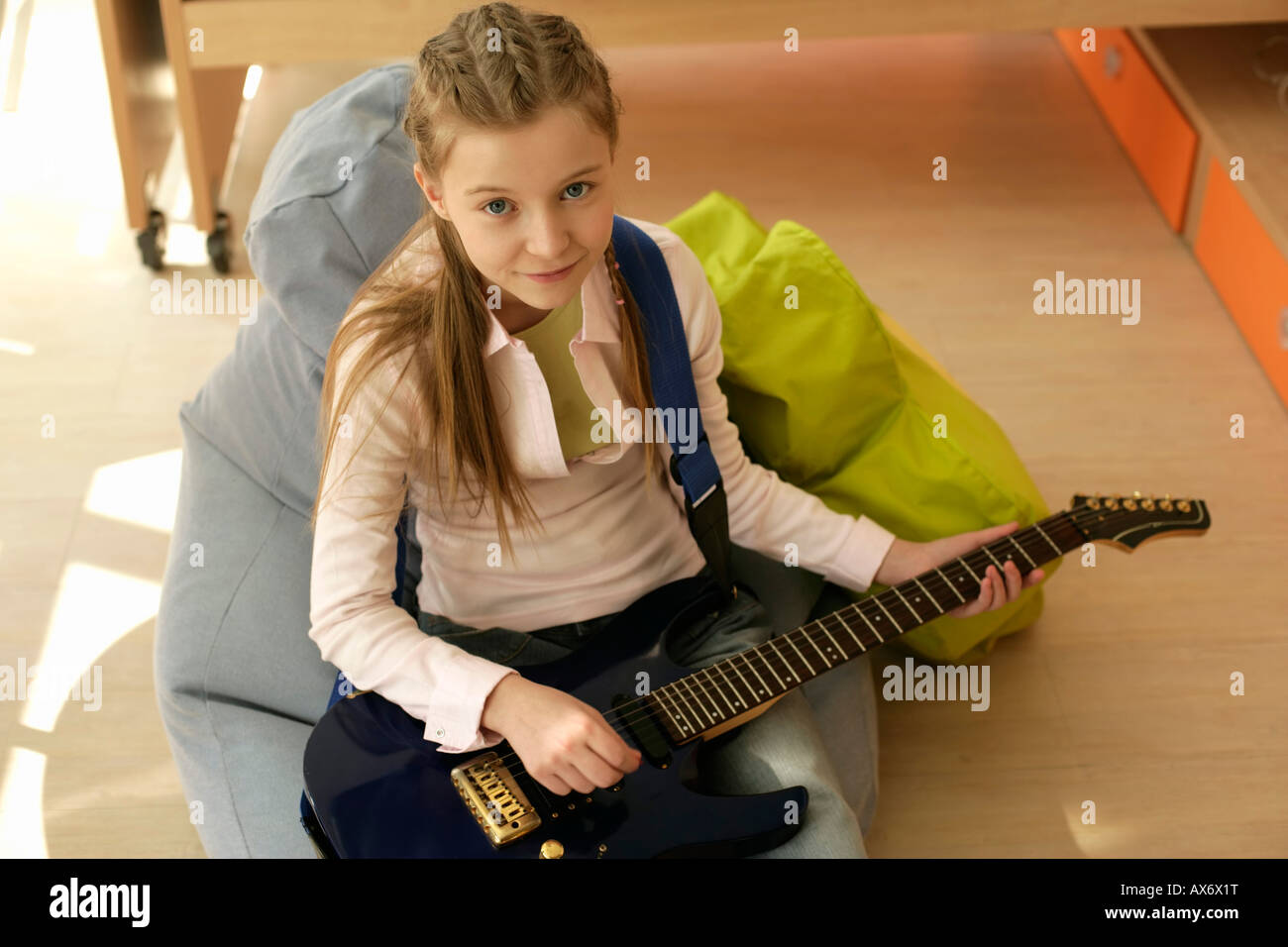 Girl holding an electric guitar Stock Photo - Alamy