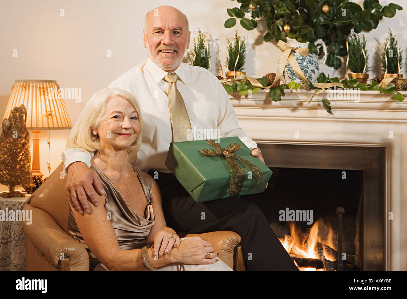 Elderly couple exchanging gifts Stock Photo