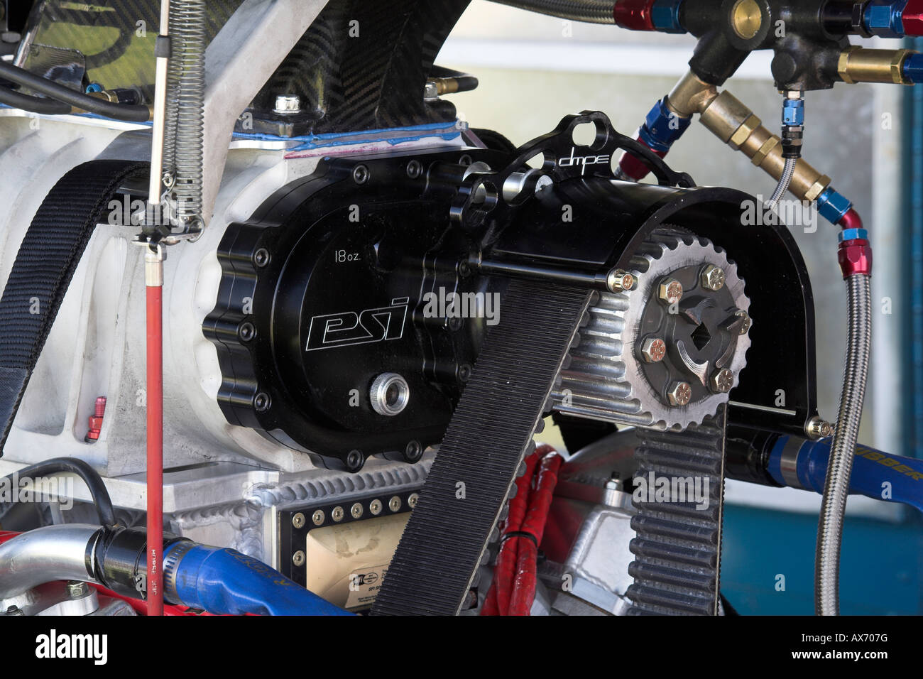 belt driven gear on the snout of a supercharger atop a V8 drag racing ...