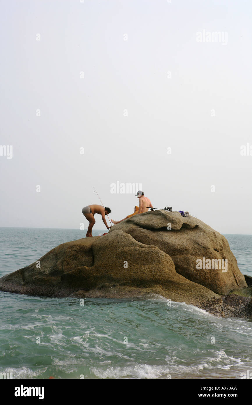 a couple at the rock catching fish Stock Photo - Alamy