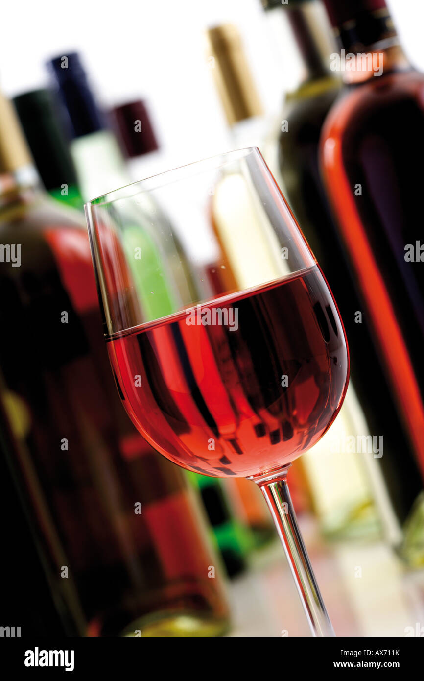Glass of rosé wine with bottles, close-up Stock Photo