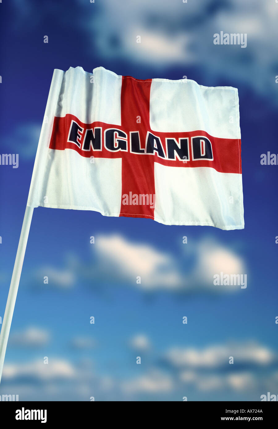 English flag of Saint George with England logo and blue sky white cloud background Stock Photo