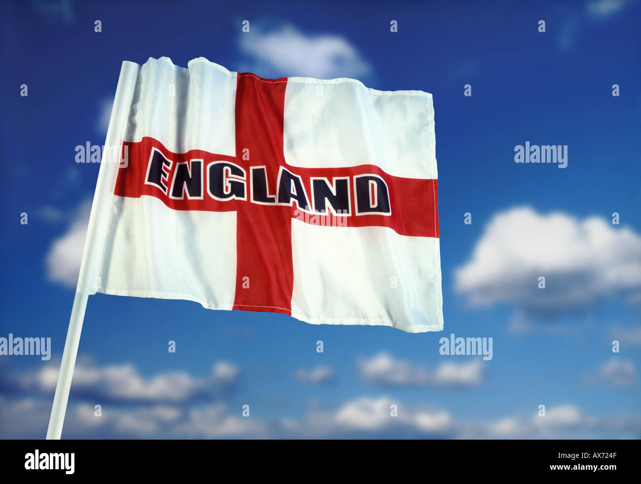 English flag of Saint George with England logo and blue sky white cloud background Stock Photo