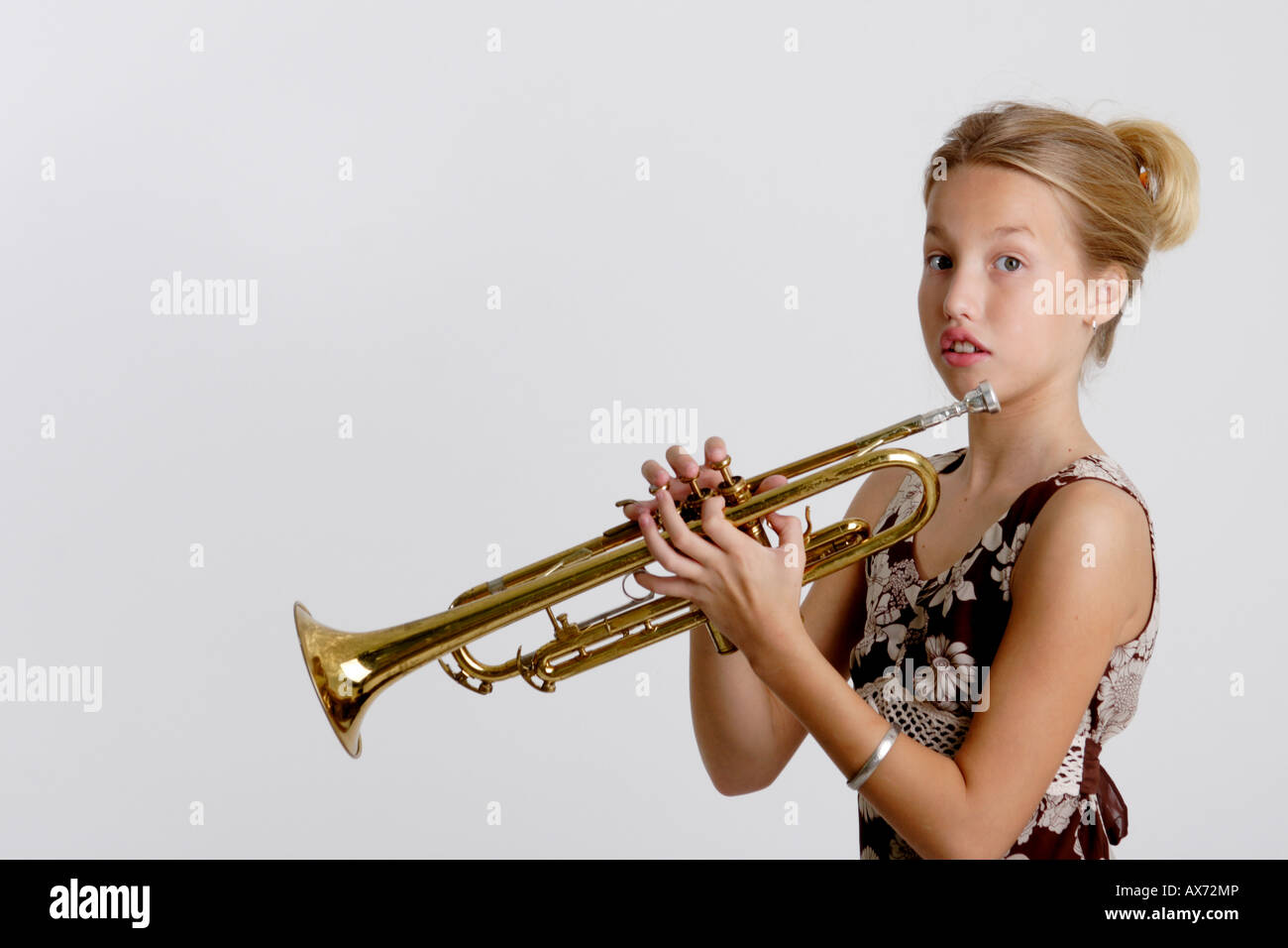 Stock Photograph of a young girl playing the trumpet Stock Photo