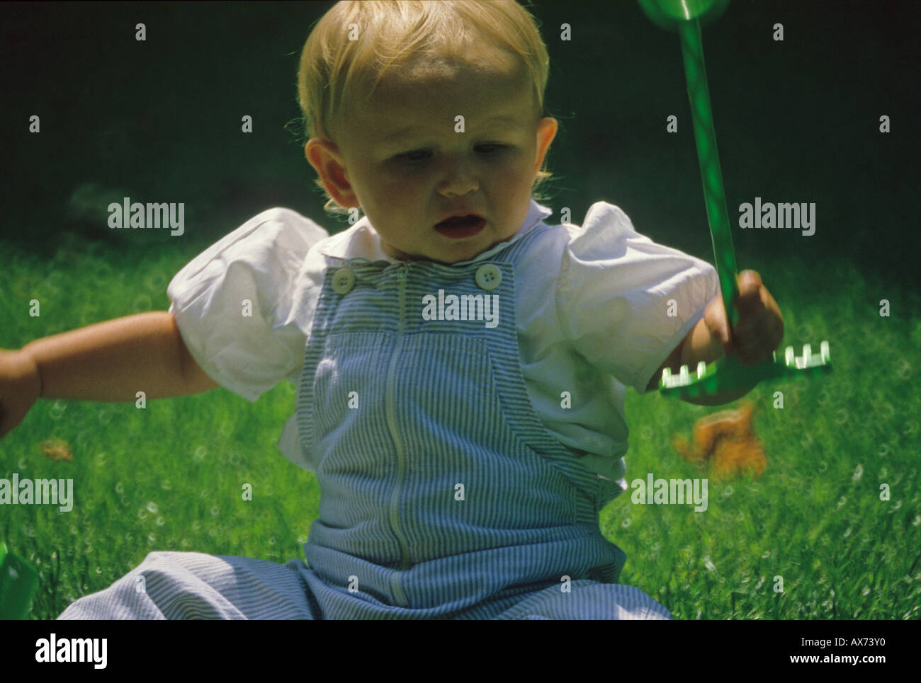 A baby playing in the park in Paris France Europe Stock Photo