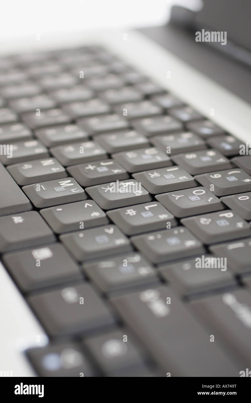 Close Up Of Laptop Keyboard With English And Chinese Characters On
