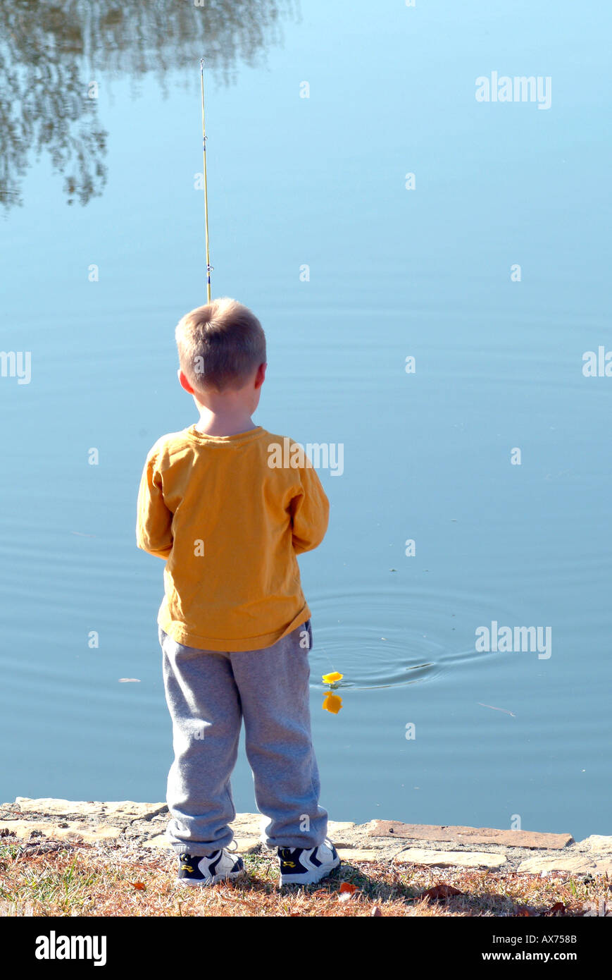 Kid holding fishing pole hi-res stock photography and images