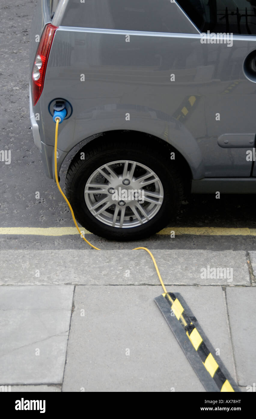 Electric car plugged in for recharging on street, City of Westminster, London SW1, Engand Stock Photo