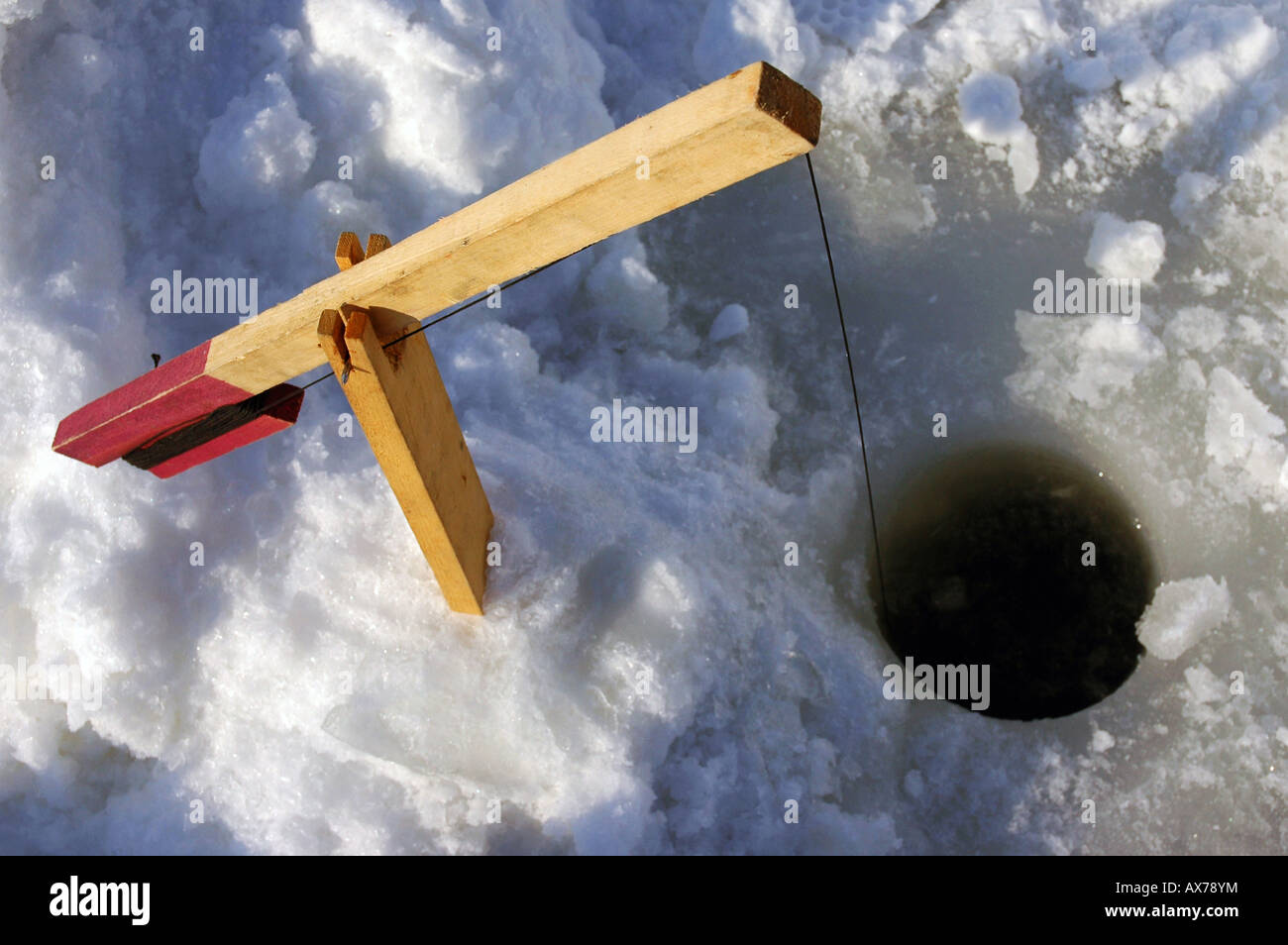 A trap setup for ice fishing on a river Stock Photo - Alamy