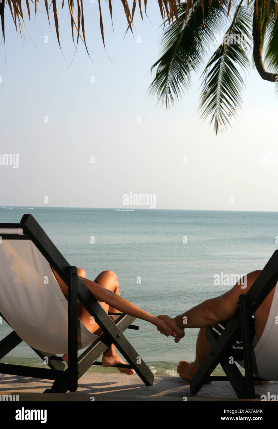 woman and man holding hands at the beach Stock Photo - Alamy