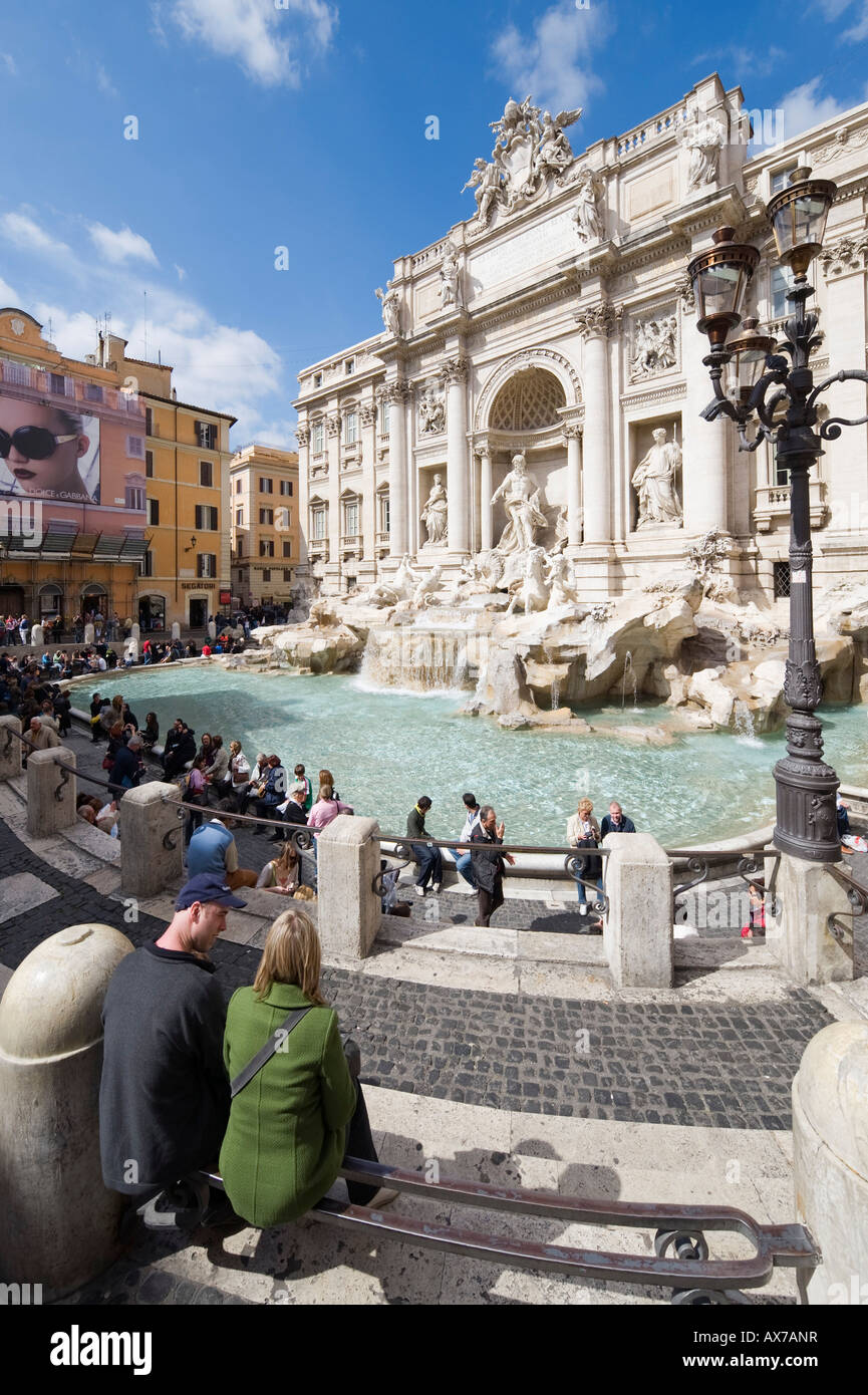 Trevi Fountain or Fontana di Trevia with a billboard for Dolce e Gabbana sunglasses to the left, Rome, Italy Stock Photo