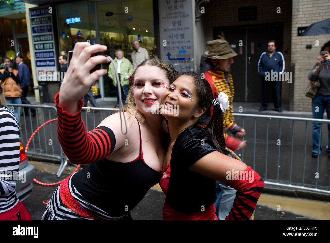 Two dancers stop along the parade route of the first New York City Dance Parade to take their own photo along Broadway. Stock Photo