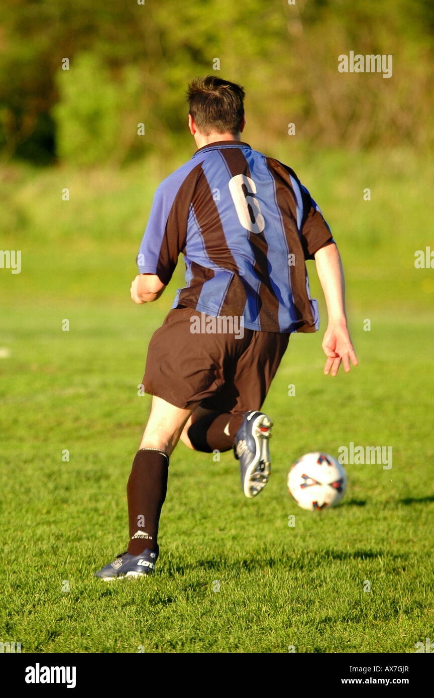 A soccer player runs with the ball Stock Photo Alamy