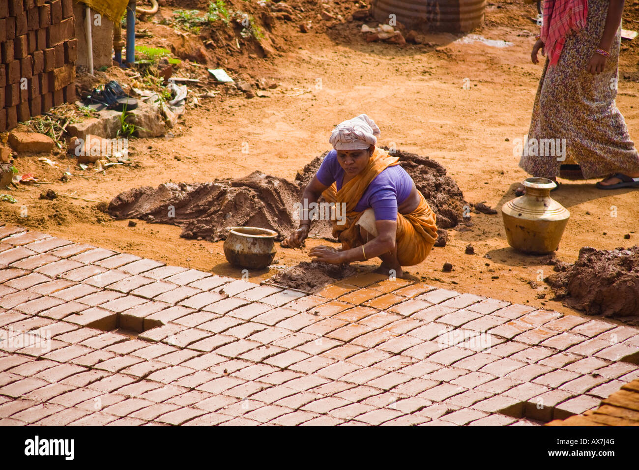 Woman making bricks from clay using a traditional method, Tamil Nadu, India Stock Photo