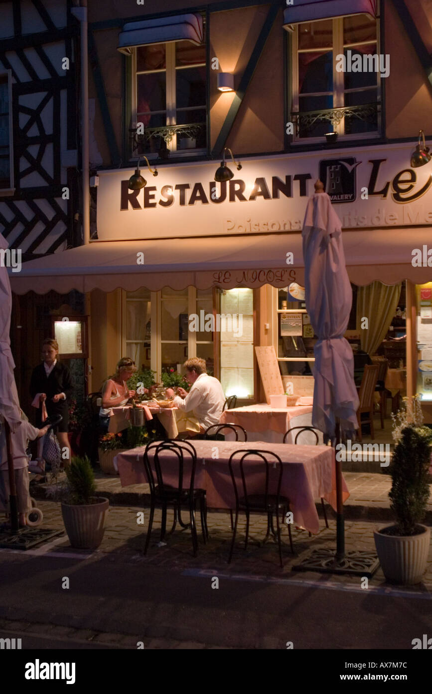 Family Enjoying Evening Meal Outside Restaurant In Centre Of St