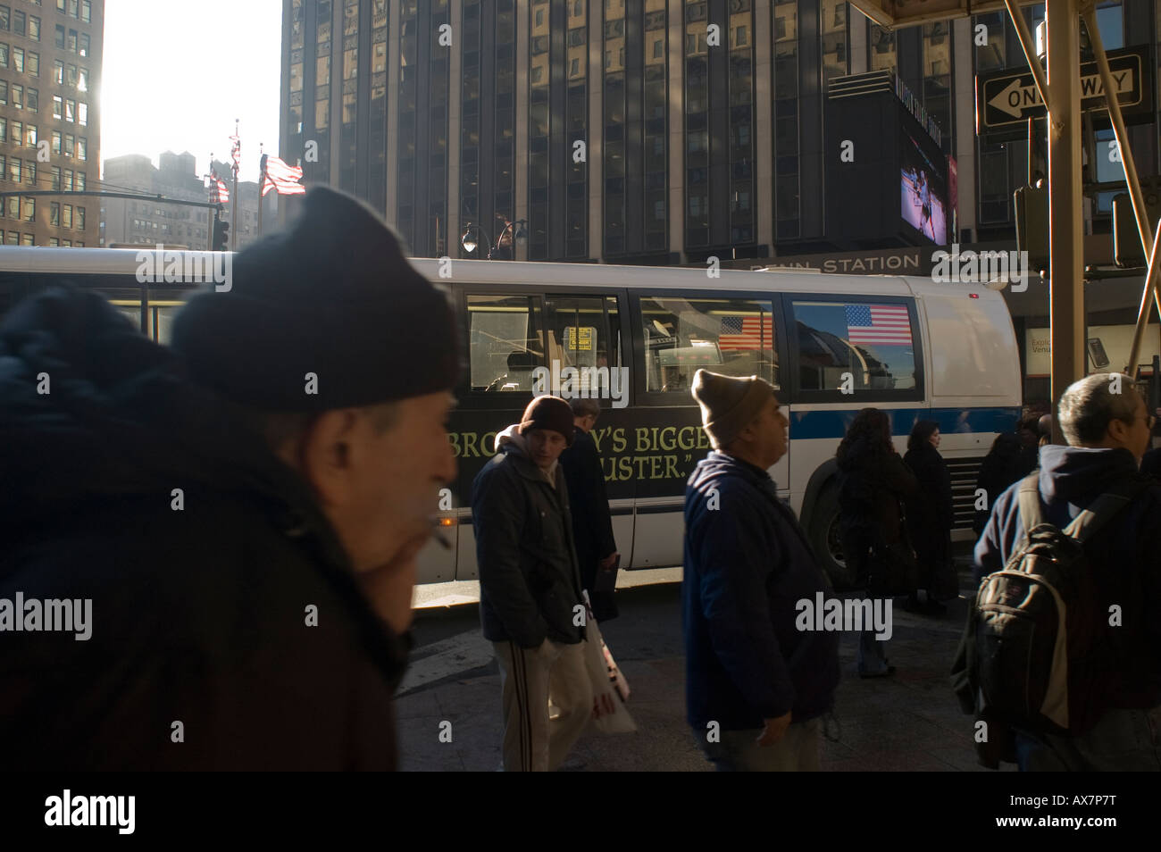 Commuters prepare to cross Seventh Avenue at Pennsylvania Station Stock Photo