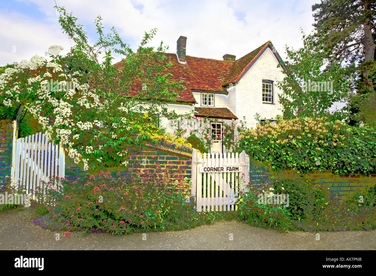 Picturesque rural cottage in summer walled garden with flowers Photoshop filter applied Stock Photo