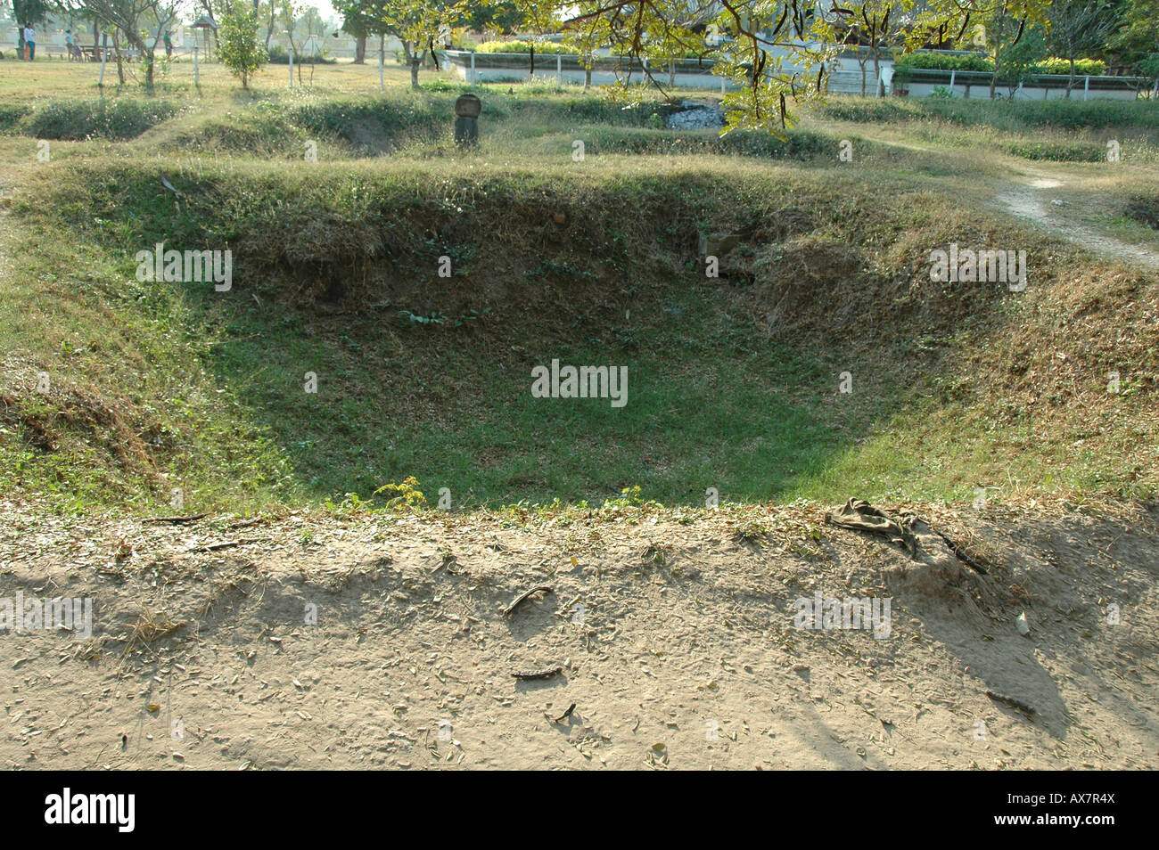 One of the excavated mass graves at The Killing Fields of Choeung Ek near Phnom Penh Cambodia Stock Photo