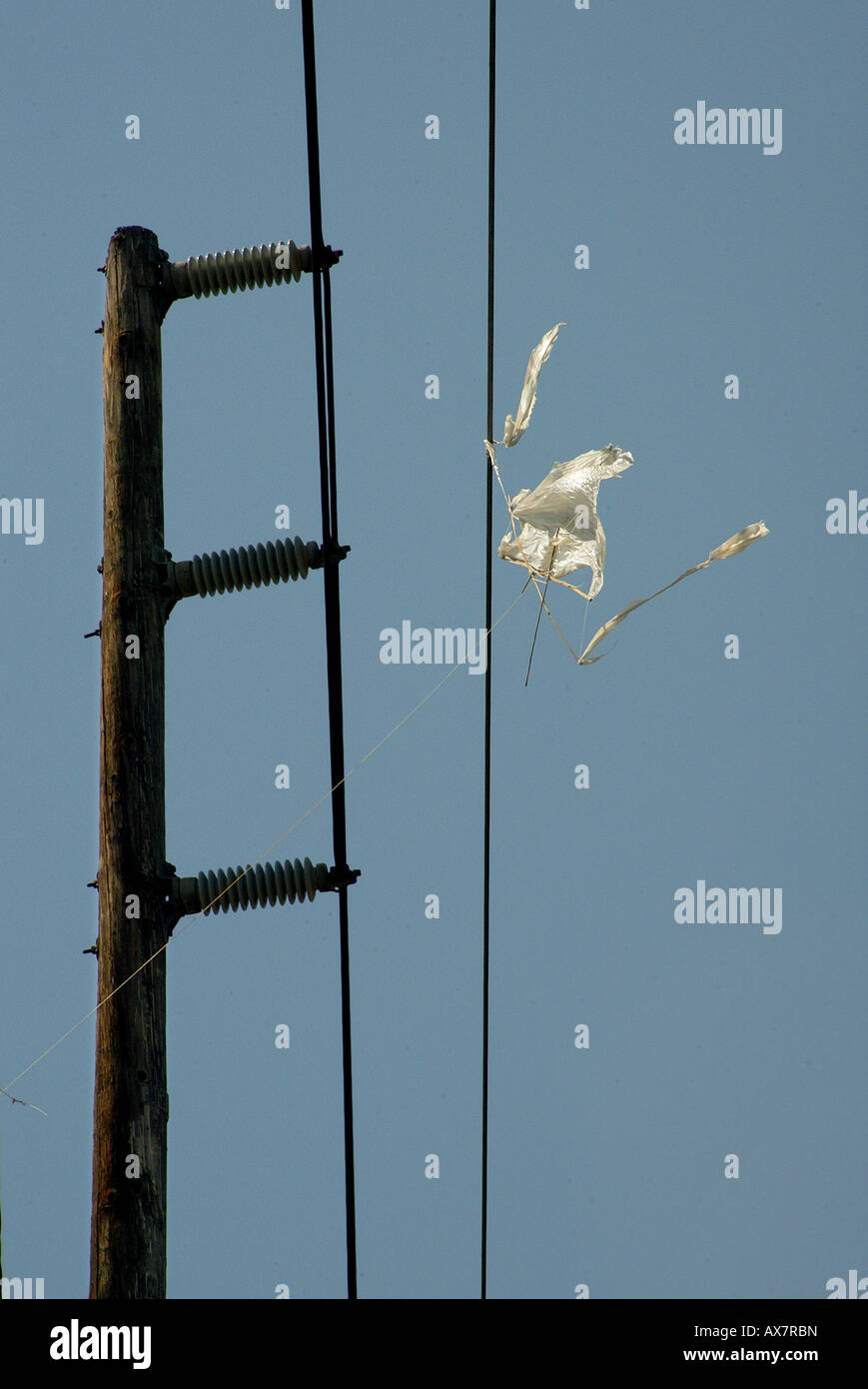 Runaway kite is stuck on high power electrical lines creating potential