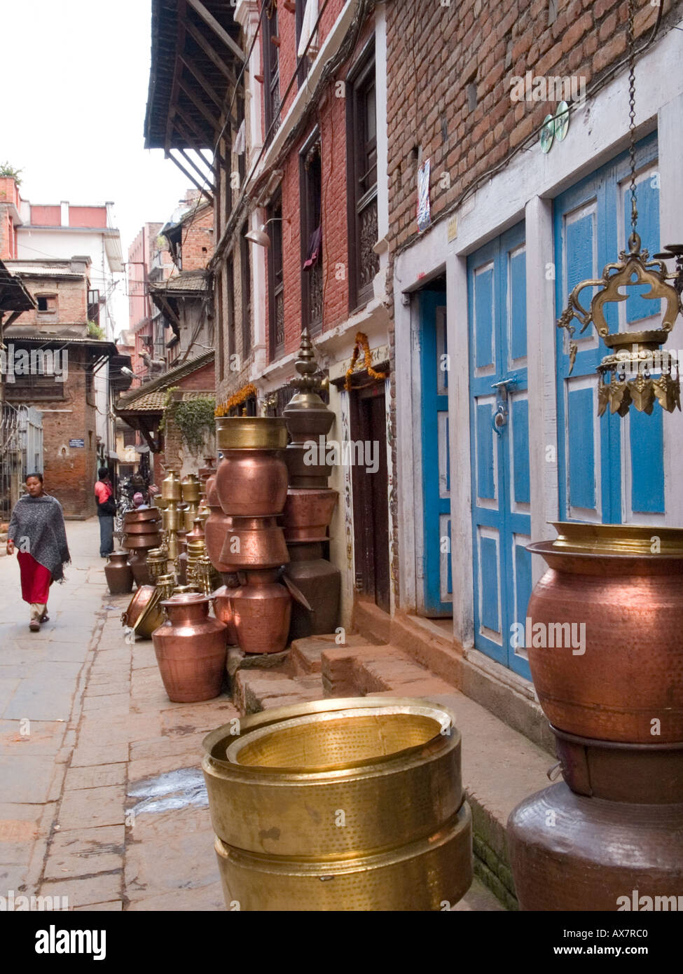 METAL POTS FOR SALE outside shop in narrow street Patan Kathmandu