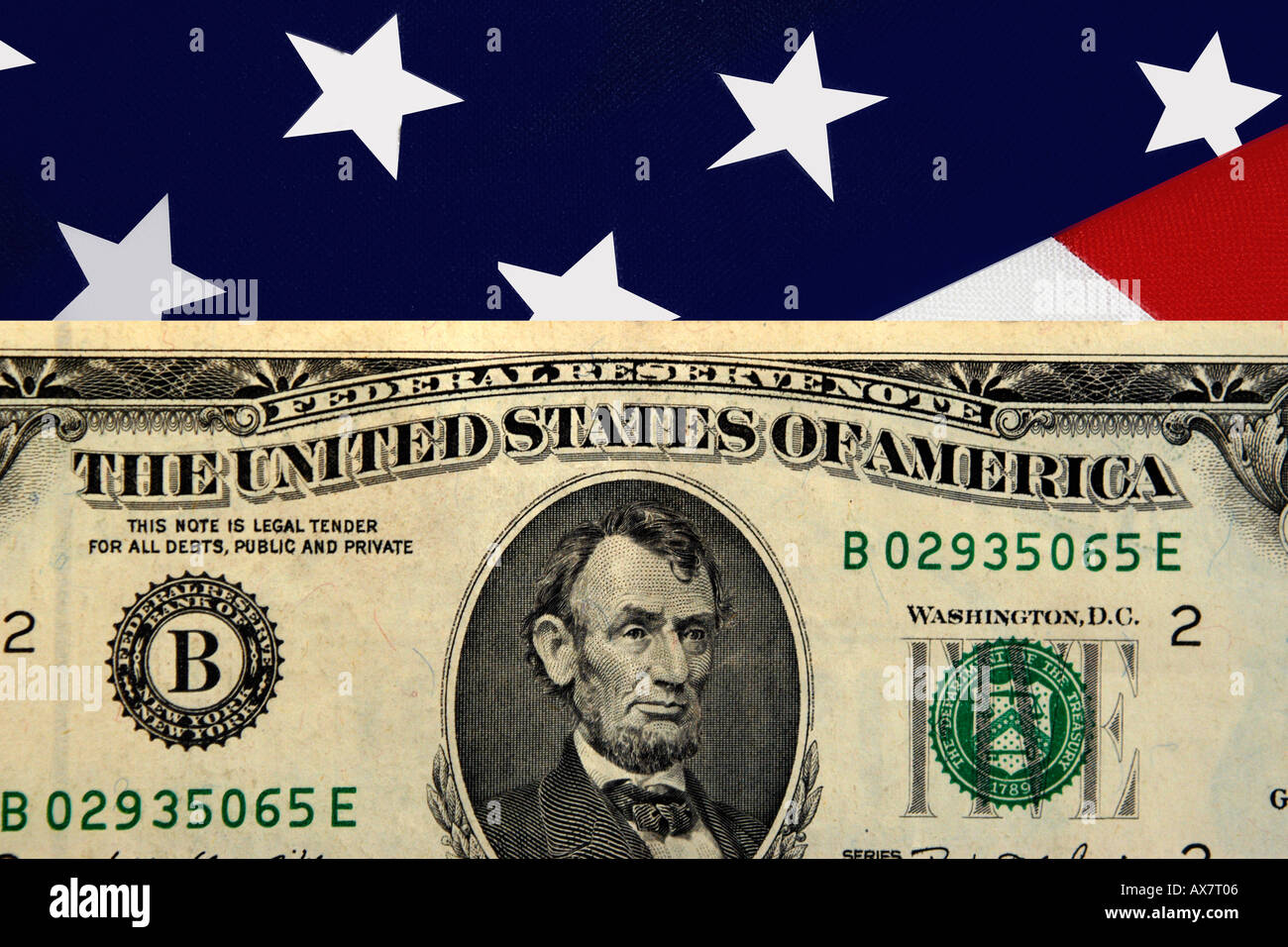 The front of an old style American Five Dollar bill set against a background of the Stars and Stripes flag. Stock Photo