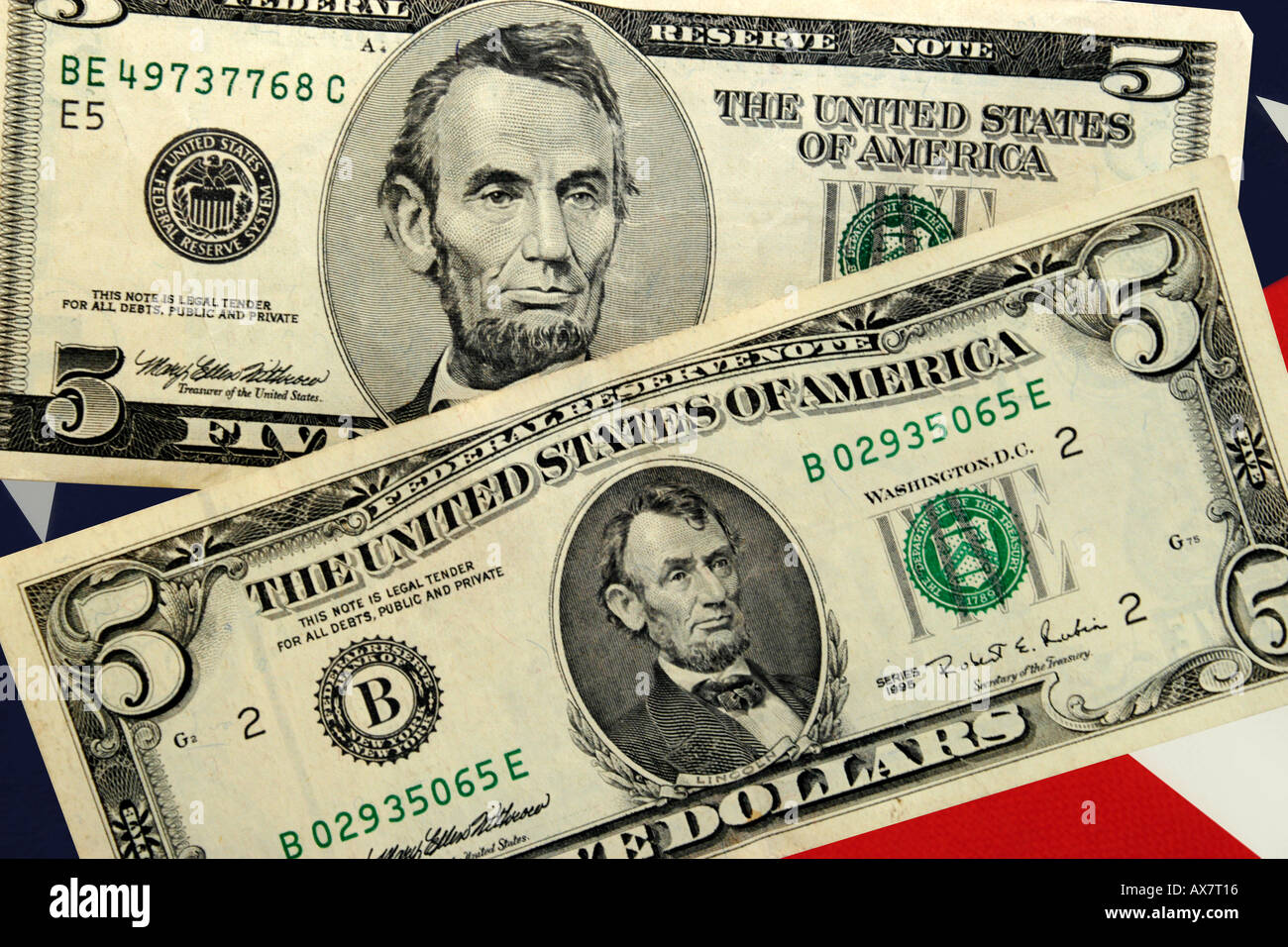 Two American 5 Dollar bills set against a Stars and Stripes background Stock Photo