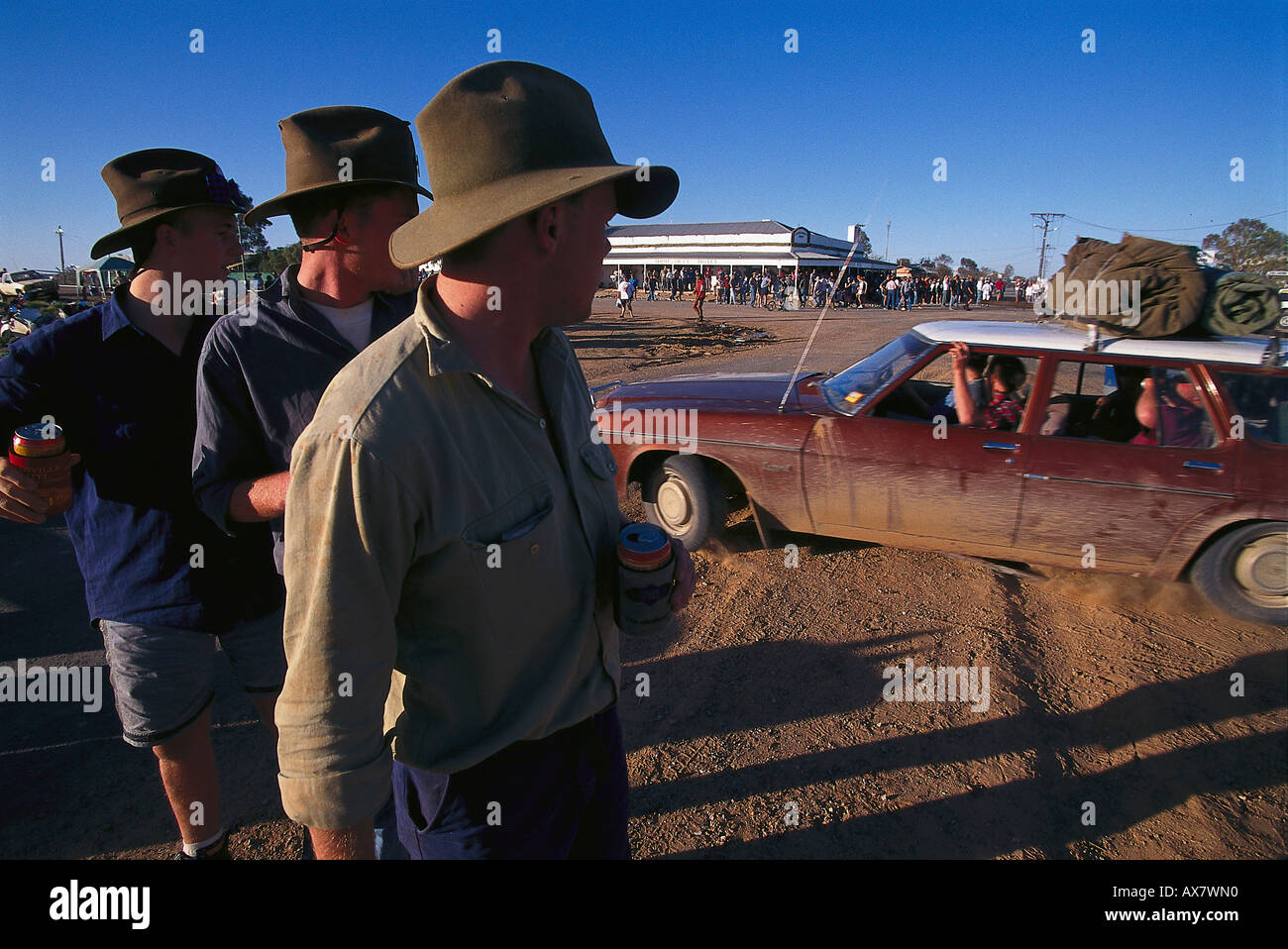 Young men looking at a car, a crowd in front of the pub, Birdsville, Simpson Desert, Queensland, Australia Stock Photo