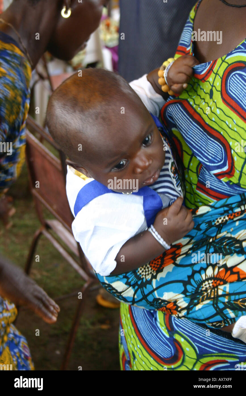 A young baby on his/her Mother's back at a traditional festival in Ghana, West Africa Stock Photo