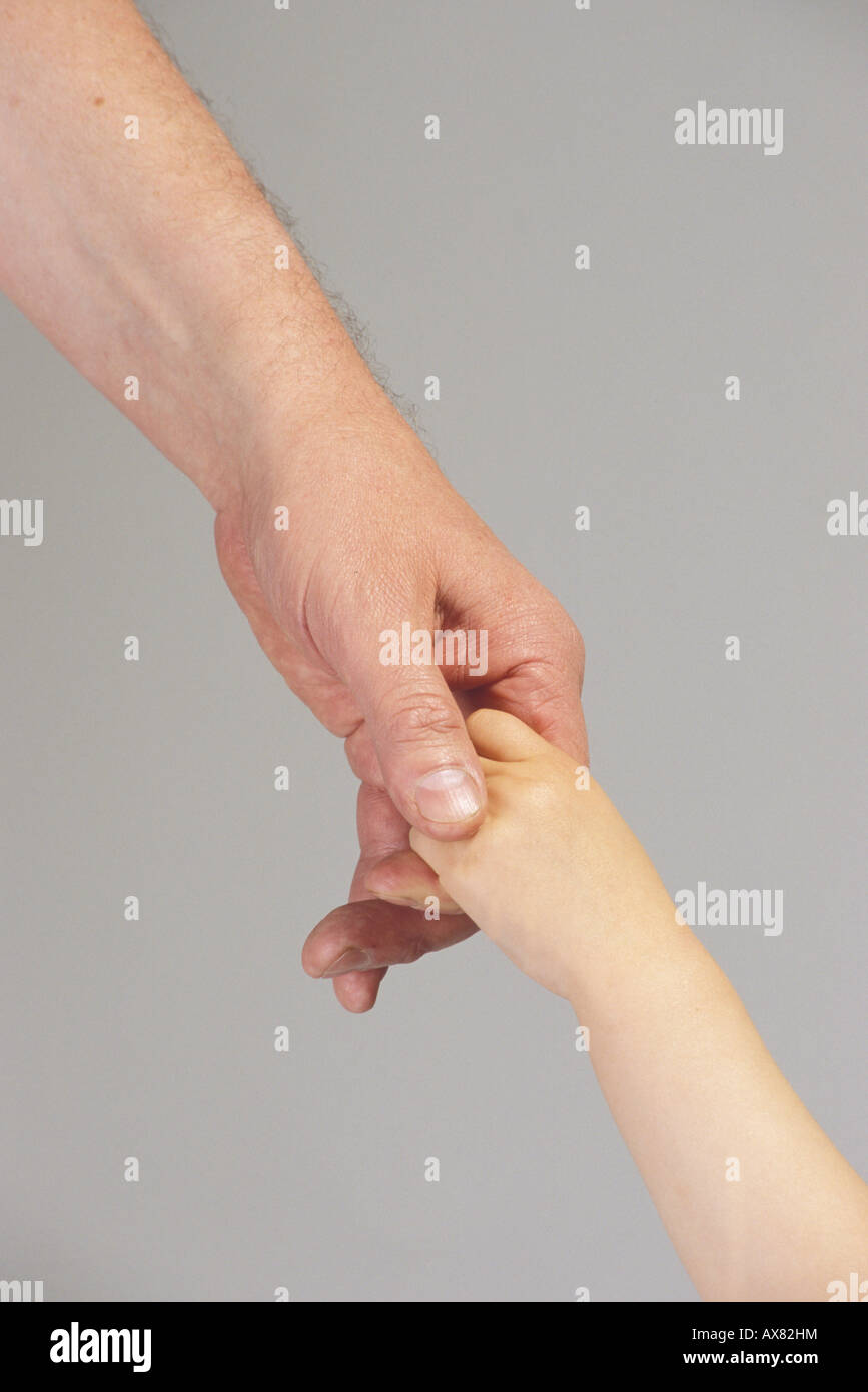Hand of an adult holds child hand Stock Photo - Alamy