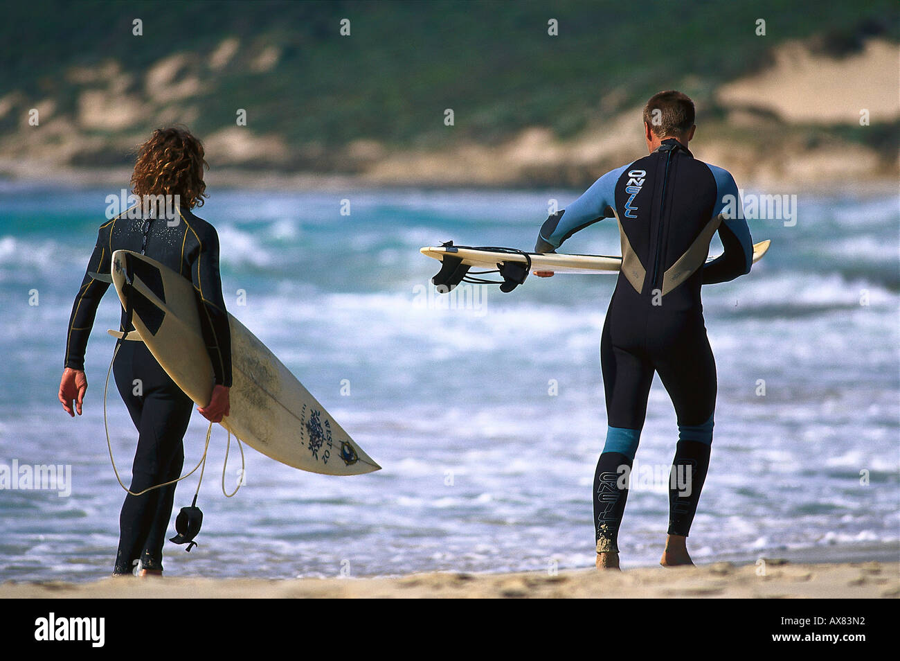 Surfers with surfboards on the beach, Smith' s Beach, Western Australia