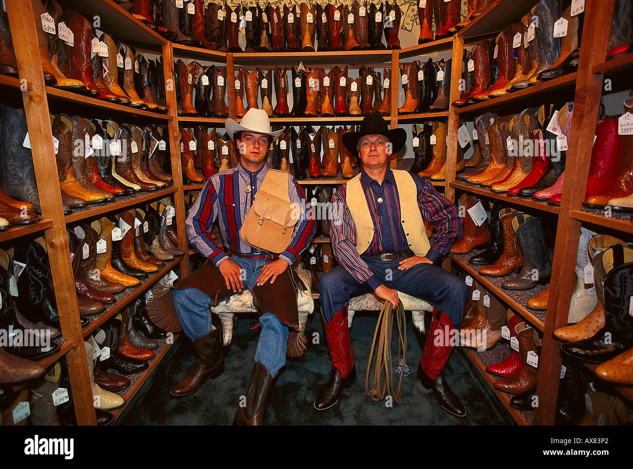 Two men wearing cowboy hats in a shop with cowboy boots, Fort Worth, Texas, USA, America Stock Photo