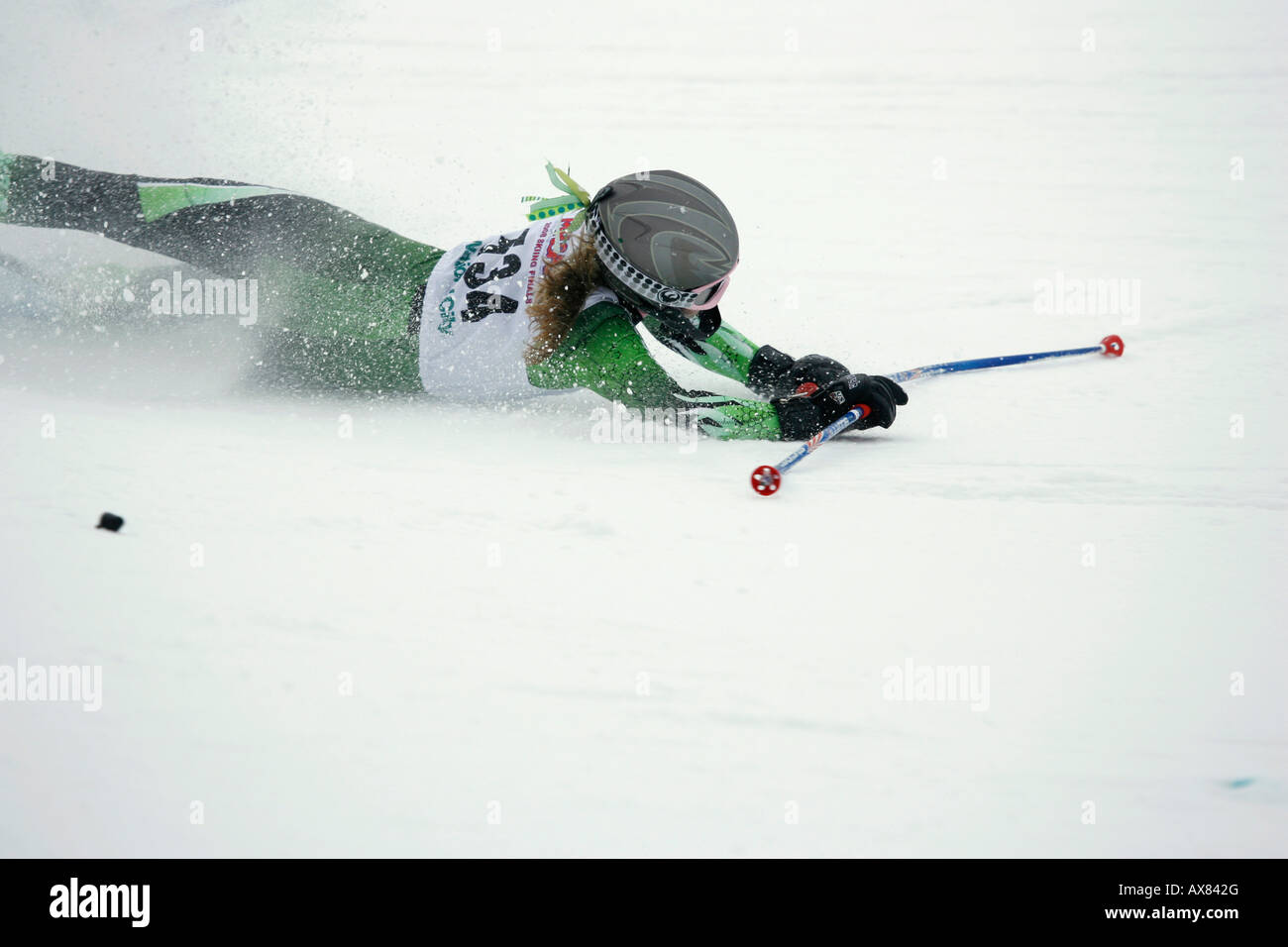 A snow skier falling during a giant slalom race. Stock Photo
