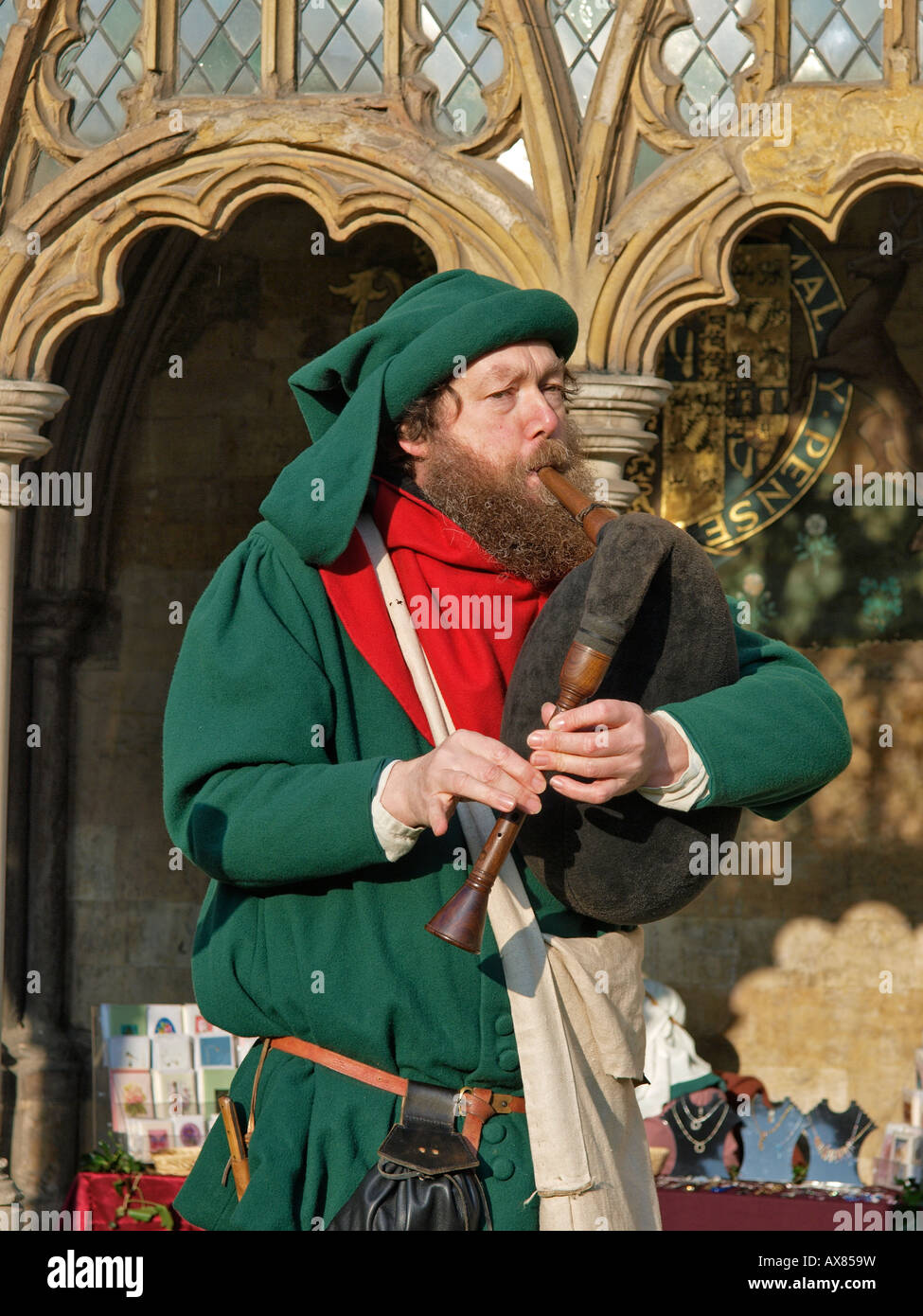 MAN DRESSED IN TRADITIONAL CLOTHING PLAYING MUSICAL INSTRUMENT NEAR TO ...