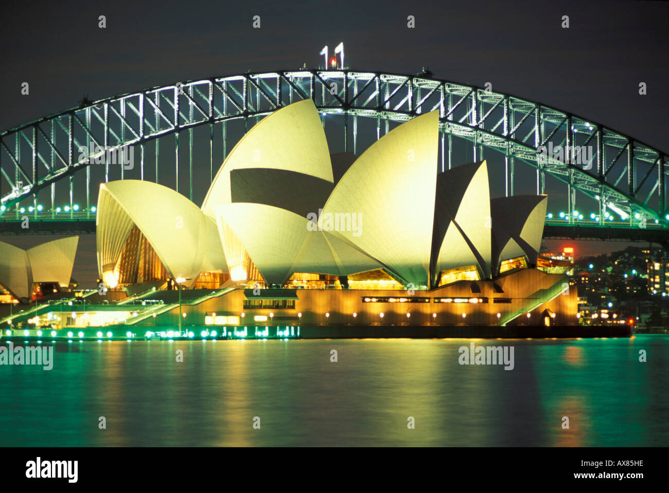 The illuminated Opera House and Harbour Bridge at night, Sydney, New