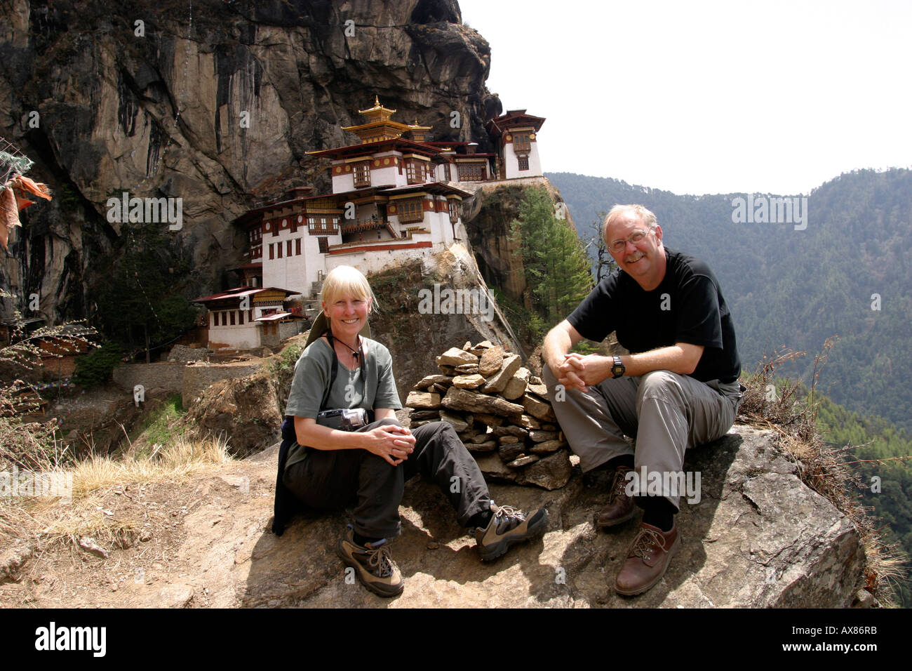 Bhutan Taktsang Tigers Nest monastery western couple resting after morning trek Stock Photo