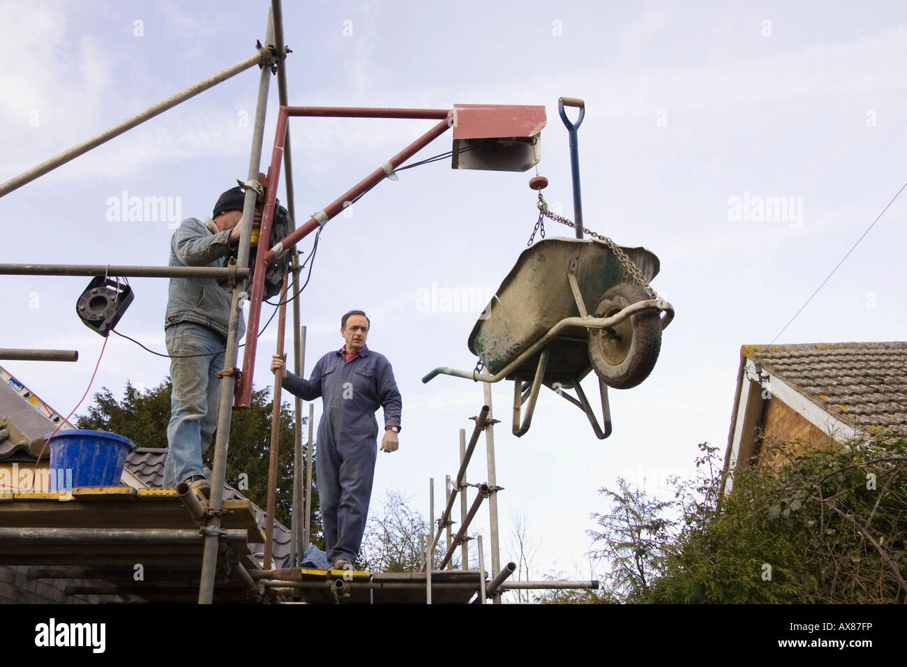 electric winch being used on a construction site to lift a Stock Photo