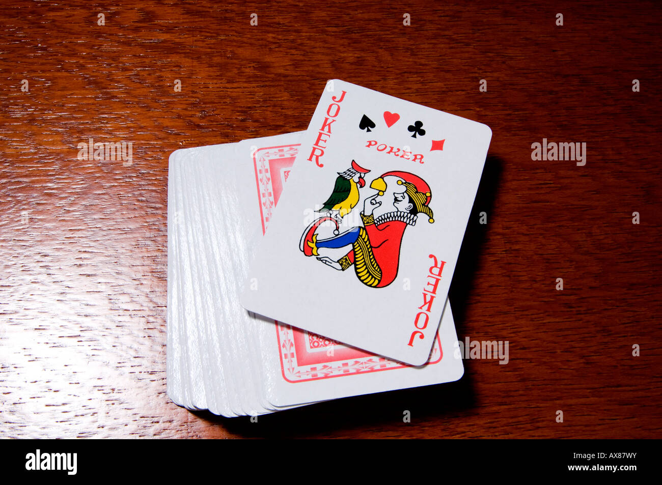 A pack of playing cards with the joker showing Stock Photo Alamy