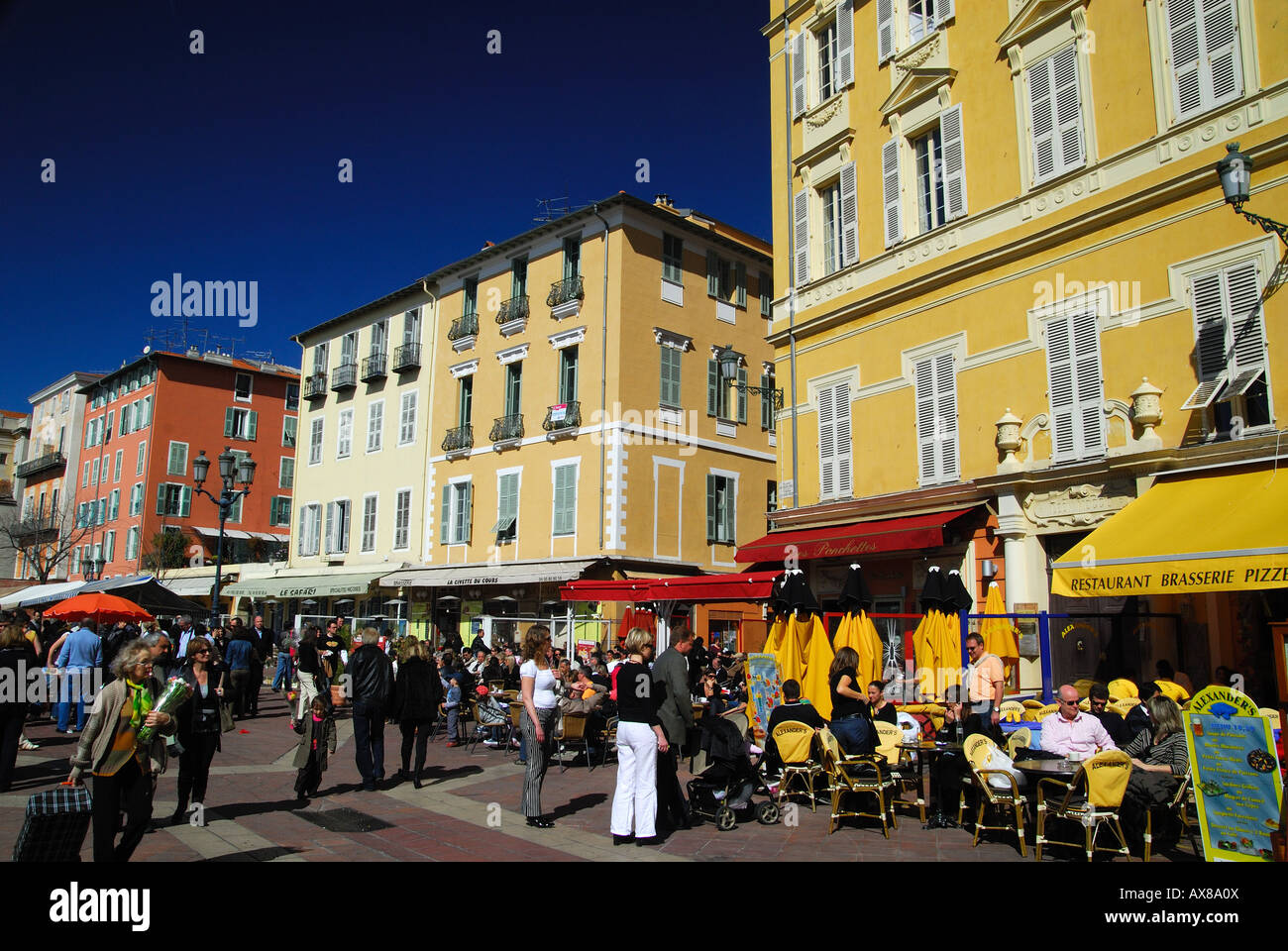 People sitting in outdoor cafes in Cours Saleya, old town of Nice, France Stock Photo