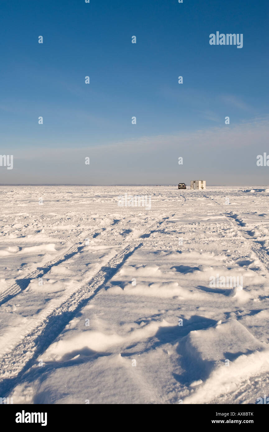 CAR TRACKS IN SNOW LEAD OUT TO AN ICE FISHING HOUSE LEECH LAKE MINNESOTA Stock Photo