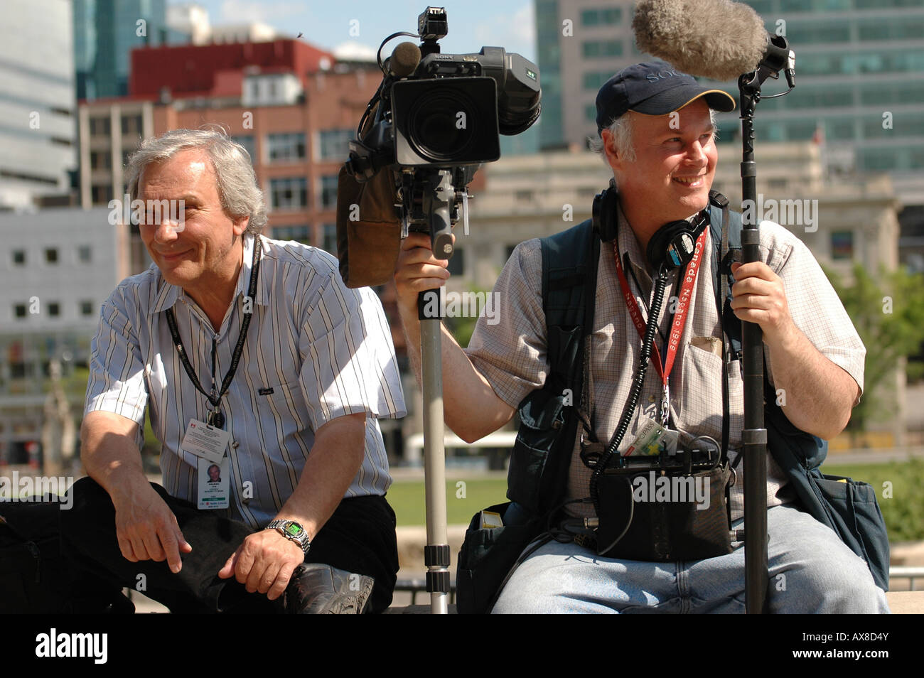 A news cameramen and audio man wait outside of Ottawas Parliament Hill to interview members of parliament Stock Photo