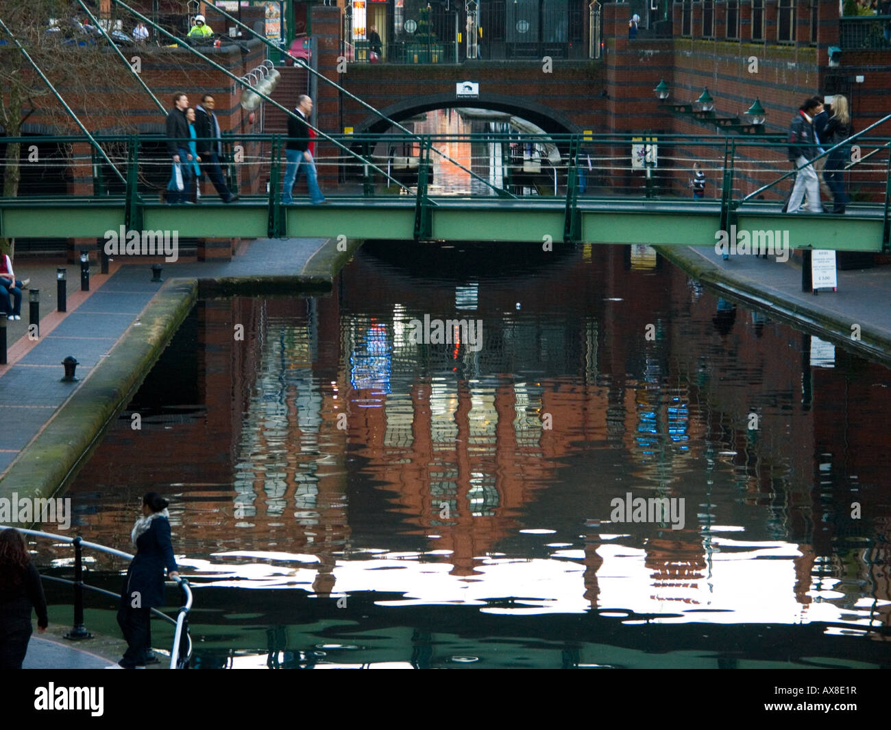 Footbridge and reflected buildings at Water's Edge, Brindley Place waterways, Birmingham, England UK Stock Photo