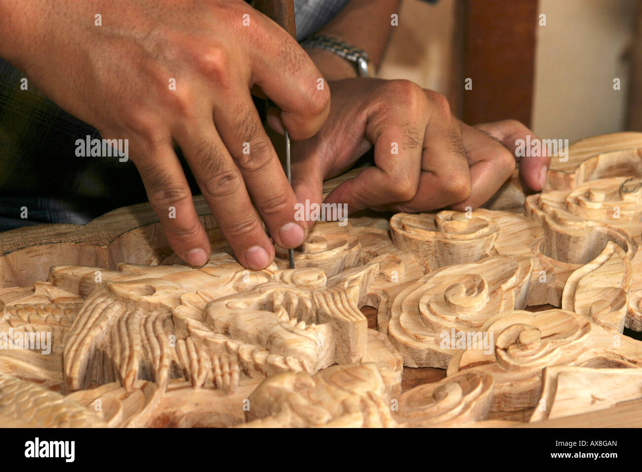 India Himachal Pradesh Norbulingka Institute Tibetan carving and carpentry school student carving dragons eye Stock Photo