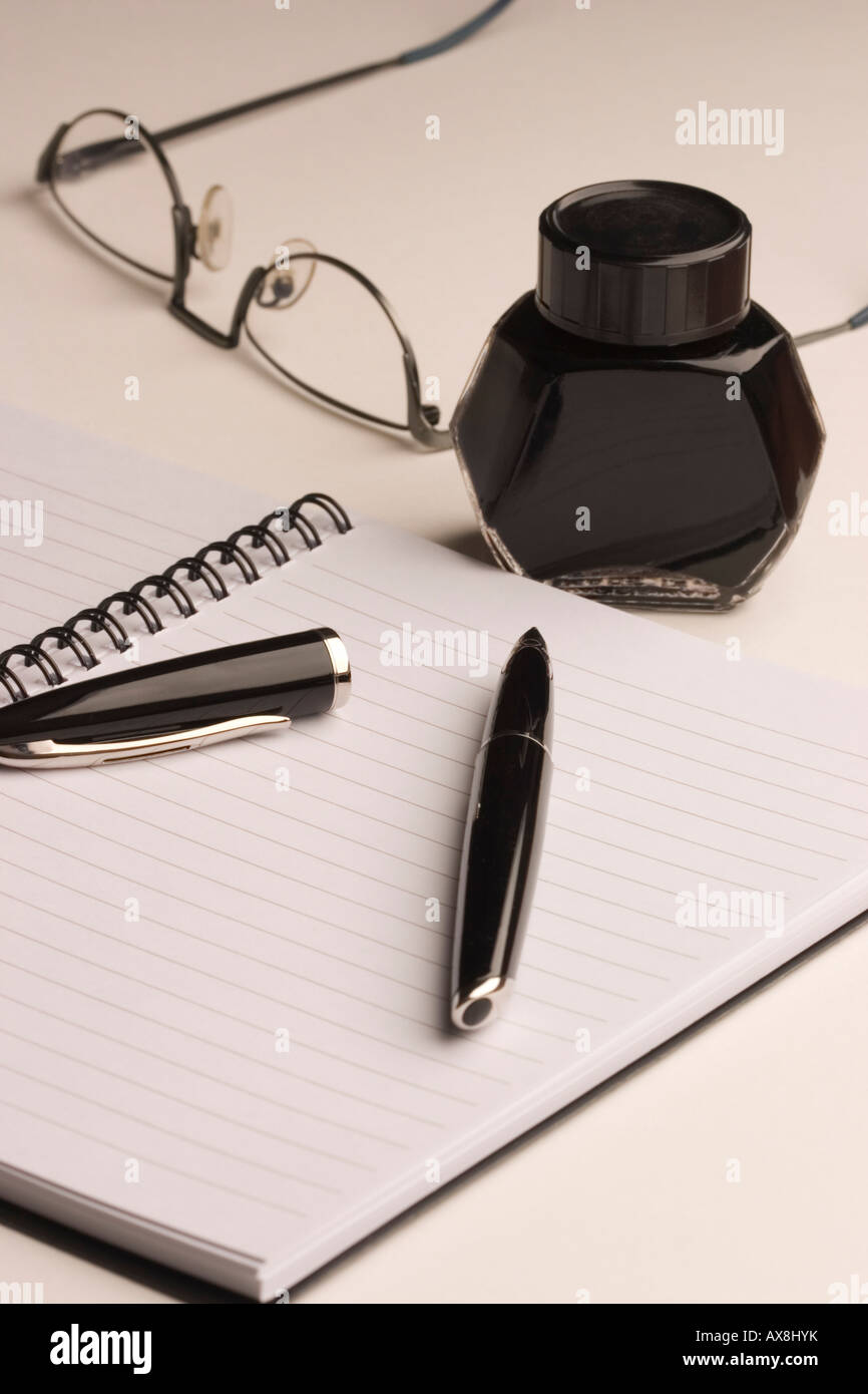 Pen Ink Notebook and Spectacles Stock Photo