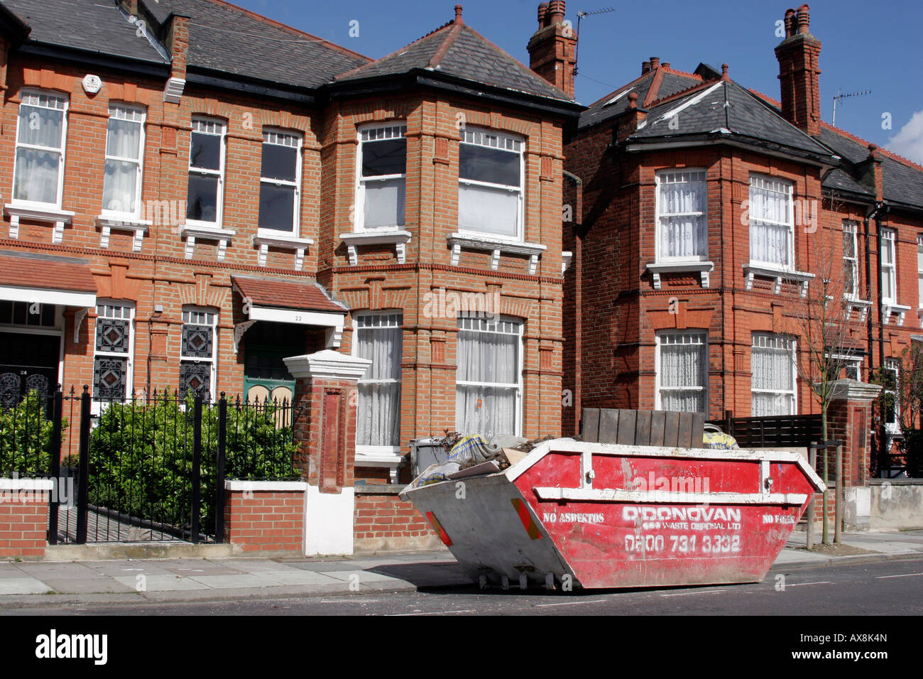 Skip outside a house in Willesden Green, North West London Stock Photo