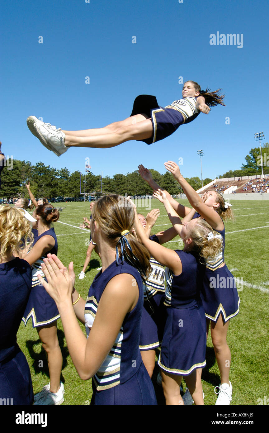 Cheerleaders Perform During Football Game doing routine that risk injury Stock Photo
